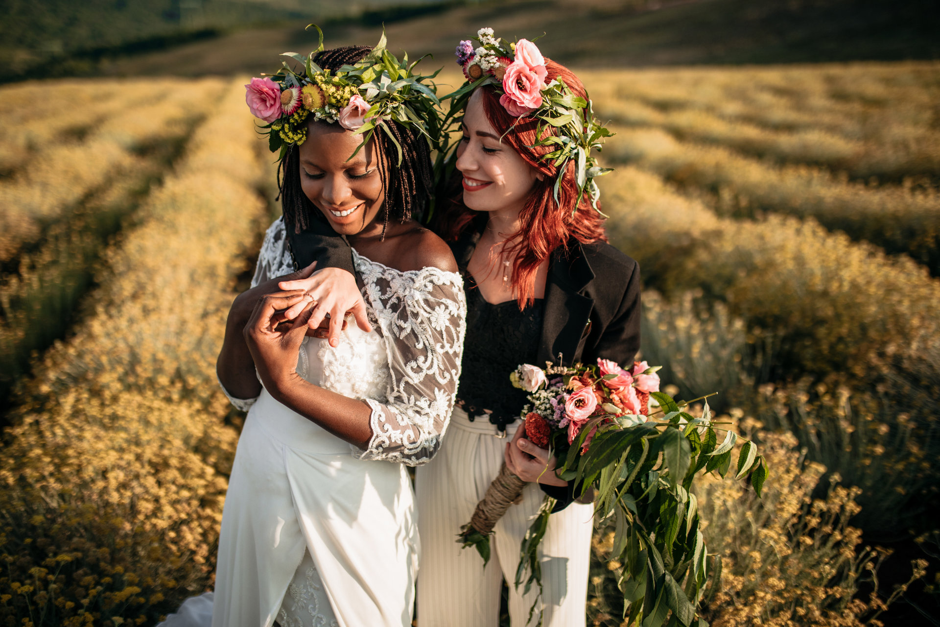 Newlyweds lesbians hugging each other in flower field